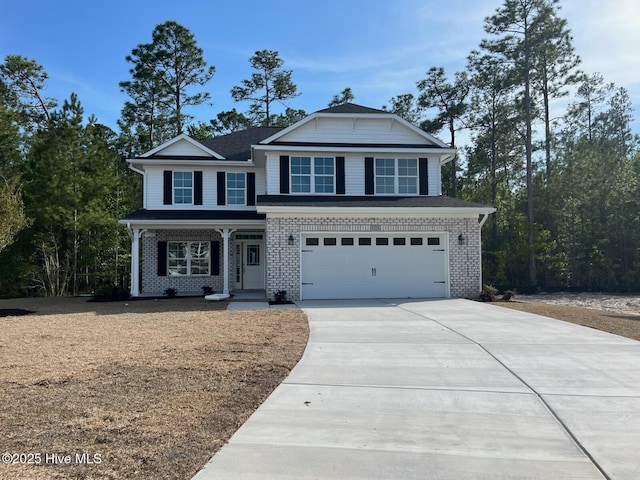 1225 Mandevilla Dr SE, Bolivia, NC 28422 - view of front of home with covered porch, concrete driveway, a garage, and brick siding