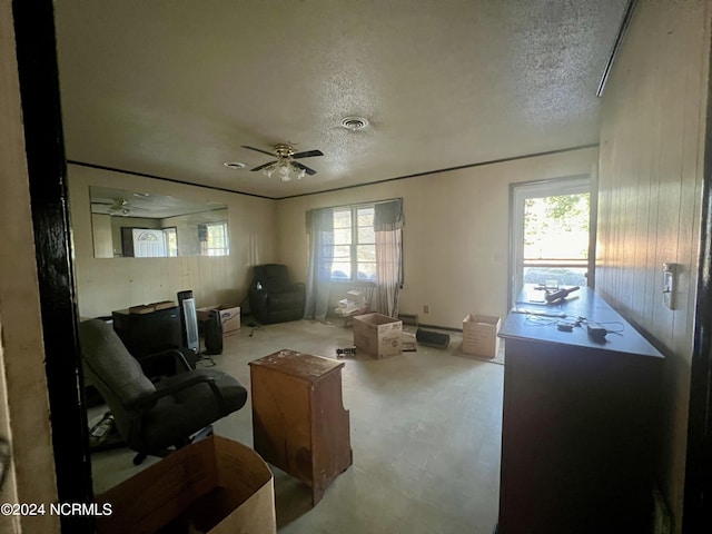 sitting room featuring ceiling fan and a textured ceiling