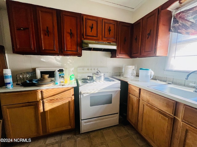 kitchen featuring white range and sink