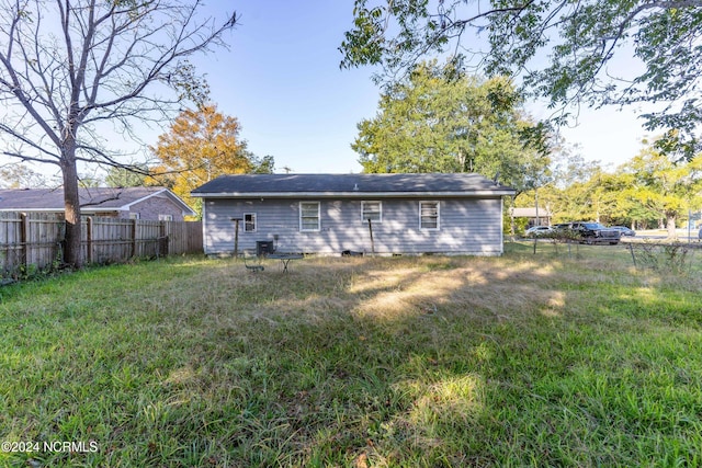 rear view of house with a yard