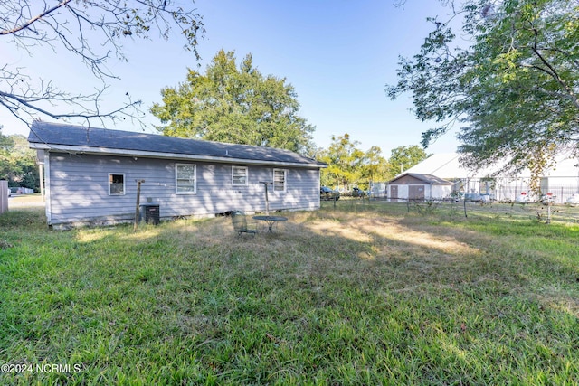 rear view of house featuring a lawn