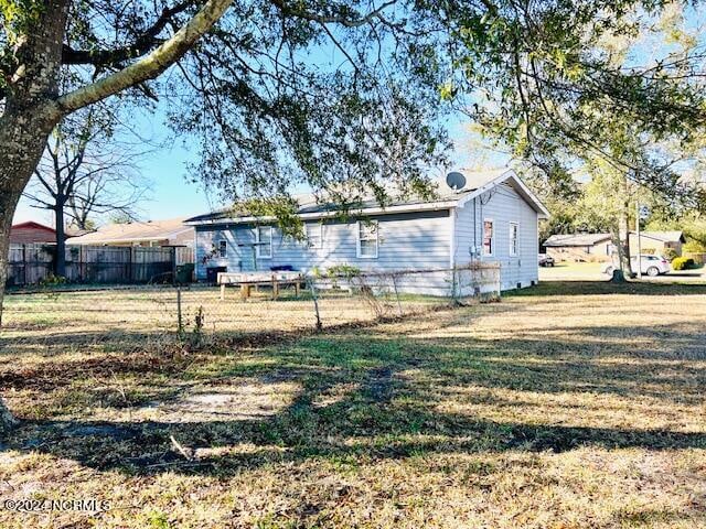 back of property featuring a lawn