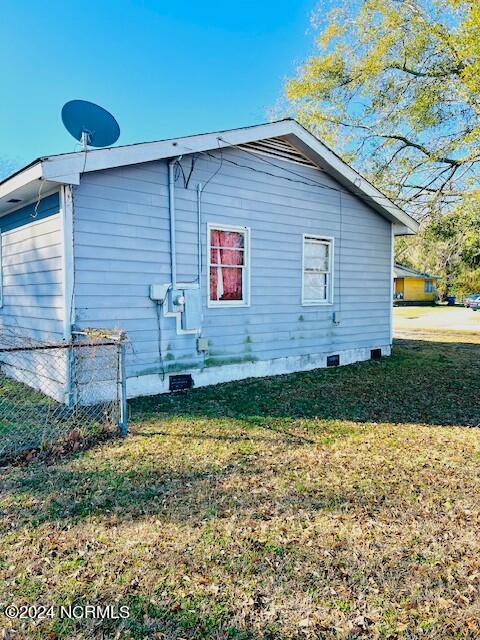 view of side of property with a yard