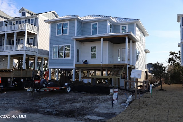 beach home with a carport, driveway, and metal roof