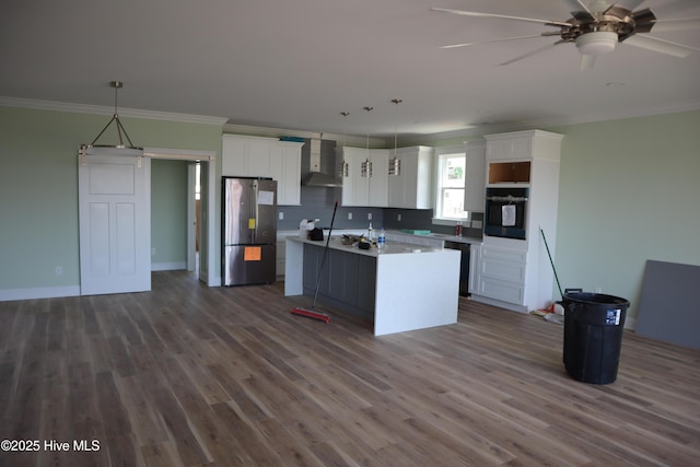 kitchen with dark wood finished floors, black appliances, white cabinetry, and wall chimney range hood