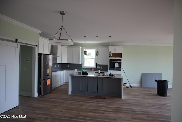 kitchen with white cabinets, oven, dark wood-type flooring, and freestanding refrigerator
