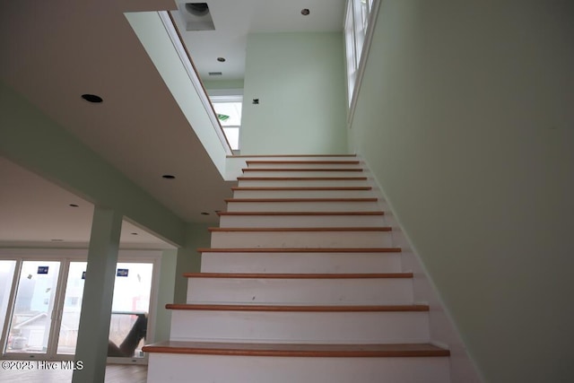 staircase featuring recessed lighting