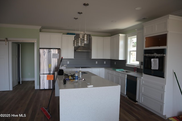 kitchen featuring a kitchen island, crown molding, dark wood-style flooring, and black appliances