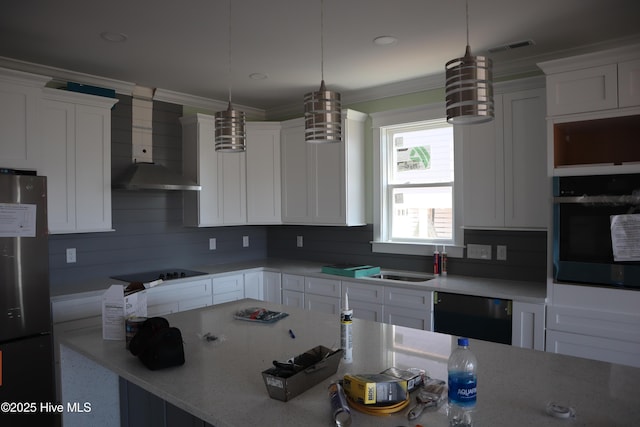 kitchen with wall chimney exhaust hood, white cabinets, visible vents, crown molding, and black appliances