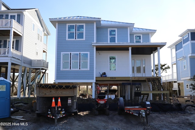 view of front of home featuring metal roof, a carport, and a standing seam roof