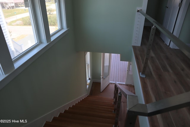 stairway with wood finished floors
