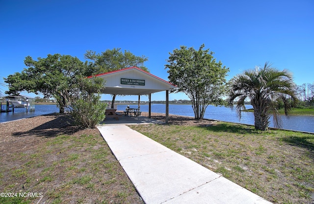 view of dock featuring a gazebo and a water view