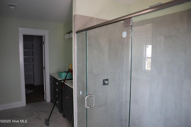 bathroom featuring visible vents, marble finish floor, and a stall shower