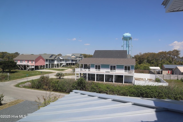 rear view of house with a balcony and a residential view
