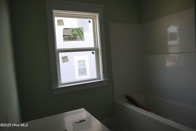 bathroom featuring walk in shower and a bathtub