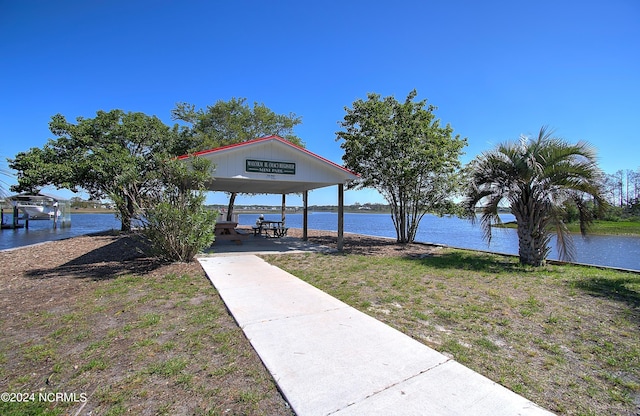 view of property's community with a gazebo and a water view