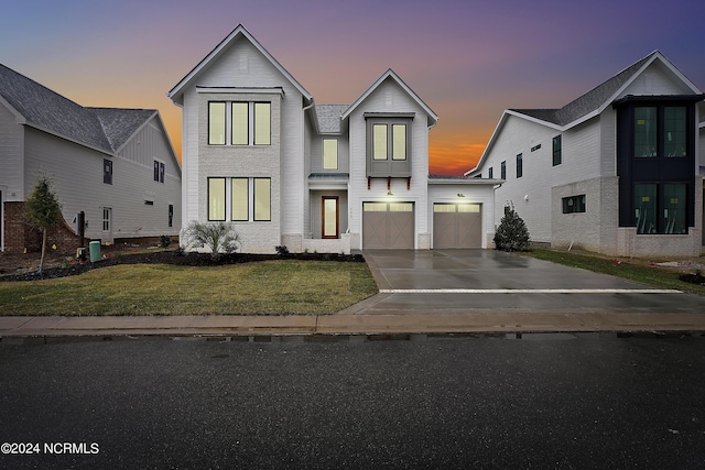 view of front of home featuring a yard and a garage