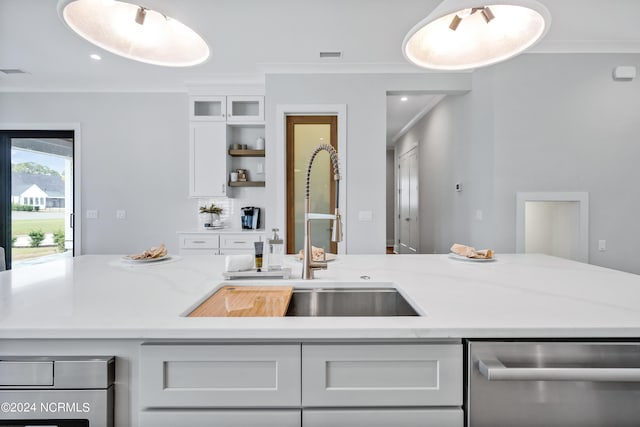 kitchen featuring dishwasher, sink, light stone counters, white cabinets, and ornamental molding