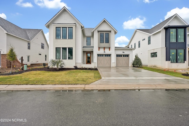 view of front of house featuring a front yard and a garage