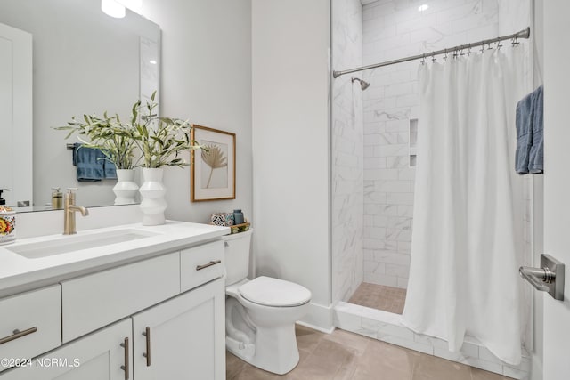 bathroom with a shower with curtain, vanity, toilet, and tile patterned floors