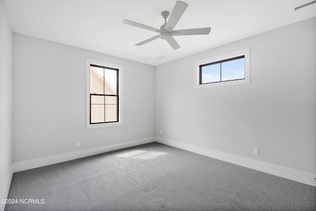 unfurnished room with ceiling fan, plenty of natural light, and carpet floors