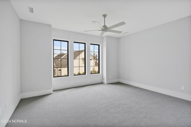 carpeted spare room with ceiling fan