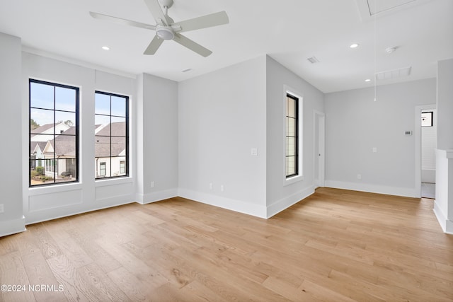 spare room with ceiling fan and light wood-type flooring