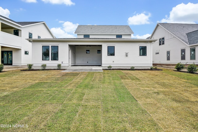 rear view of property featuring a patio and a lawn