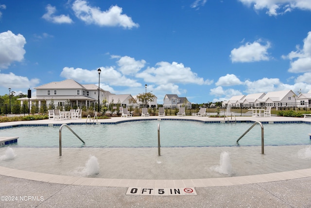 view of pool featuring pool water feature and a patio area