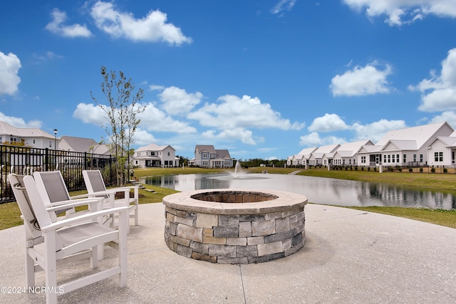 view of patio featuring a fire pit and a water view