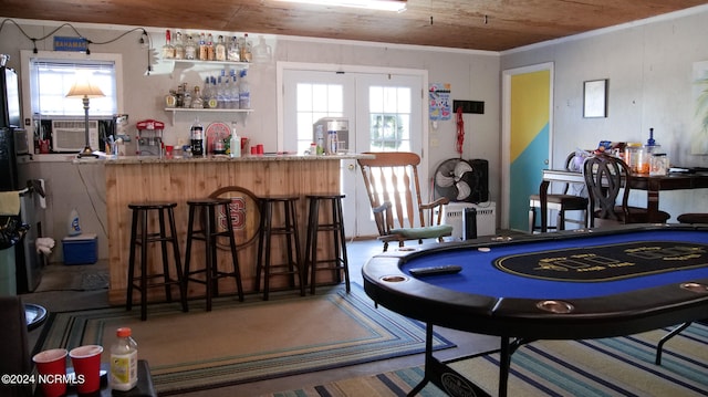 playroom featuring ornamental molding, french doors, wooden ceiling, and bar