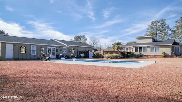 view of swimming pool featuring a patio and french doors