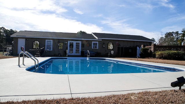 view of swimming pool featuring french doors and a patio