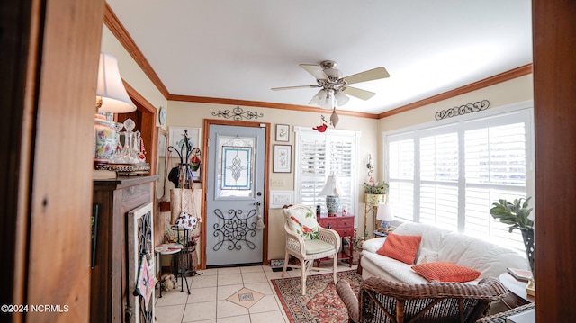 tiled entrance foyer with ceiling fan and ornamental molding