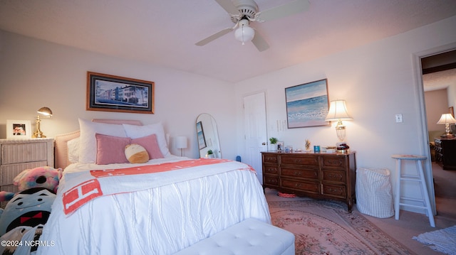 bedroom with ceiling fan and dark carpet