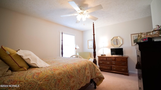 bedroom with light carpet, a textured ceiling, and ceiling fan