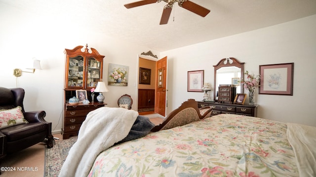 carpeted bedroom with lofted ceiling, ceiling fan, and a textured ceiling