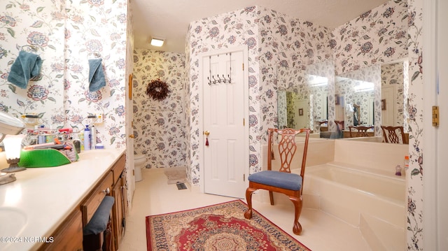 bathroom featuring toilet, tile floors, a textured ceiling, vanity, and a bathtub