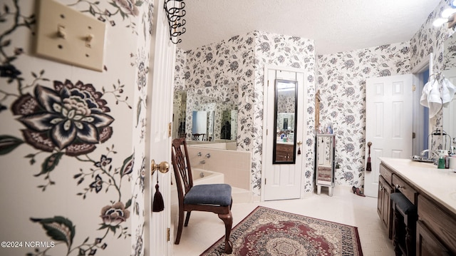 bathroom with tile flooring, vanity, and a textured ceiling