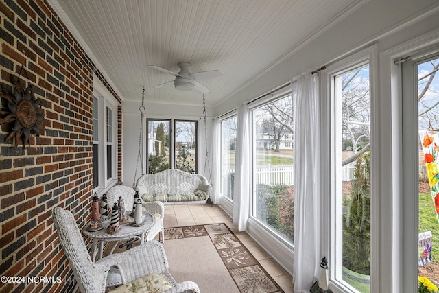 sunroom featuring plenty of natural light and ceiling fan