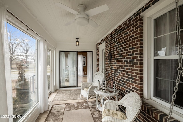 sunroom featuring ceiling fan