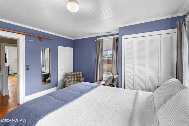 bedroom with ornamental molding, a closet, and dark wood-type flooring