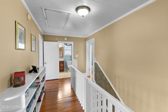 hallway with ornamental molding and hardwood / wood-style flooring