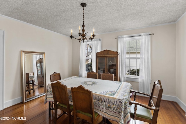 dining room featuring a textured ceiling, dark hardwood / wood-style floors, and an inviting chandelier