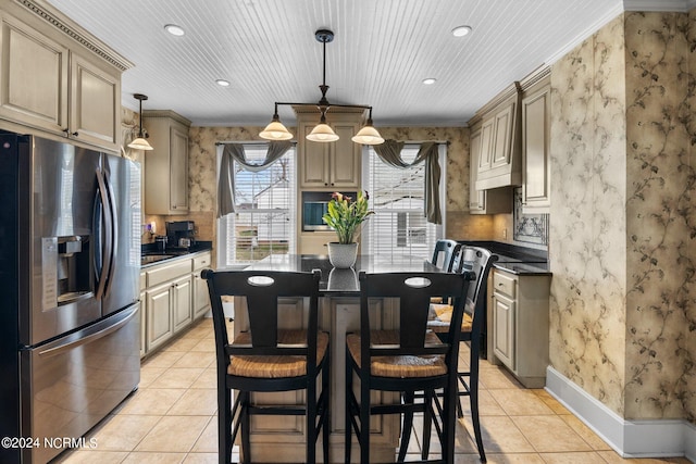 kitchen with stainless steel fridge, light tile floors, pendant lighting, a kitchen island, and ornamental molding