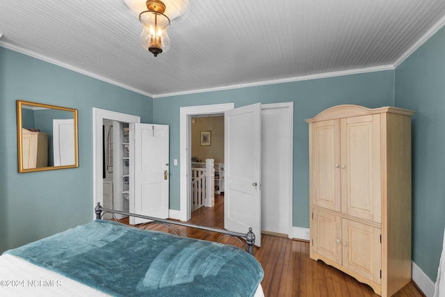 bedroom featuring ornamental molding and dark wood-type flooring