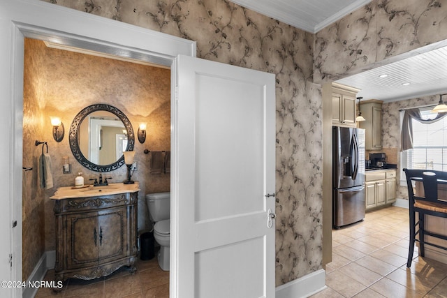 bathroom featuring tile floors, oversized vanity, toilet, and crown molding