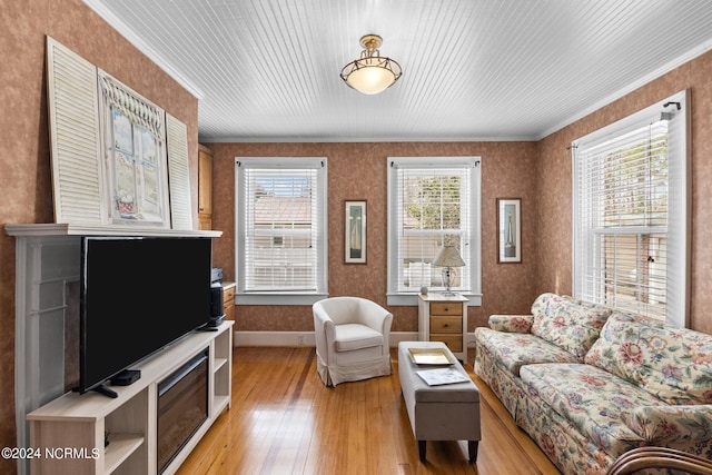 living room with ornamental molding and light wood-type flooring