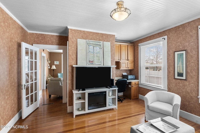 living room featuring light hardwood / wood-style flooring, crown molding, and french doors