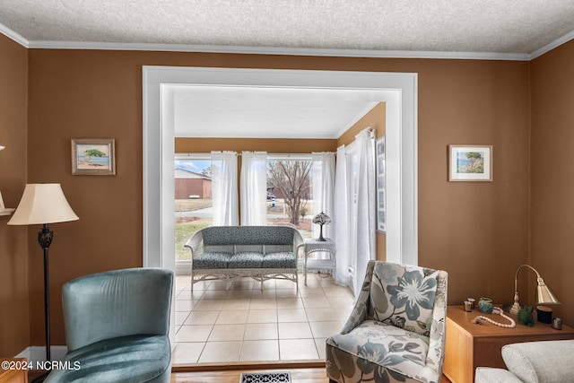 living area with a textured ceiling, light tile flooring, and ornamental molding